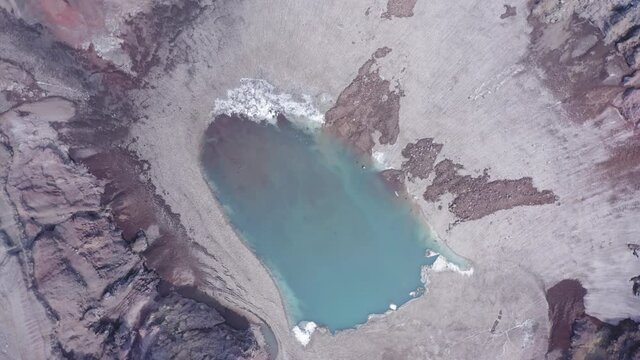 The blue lake in the crater of Gorely volcano. Kamchatka Peninsula, Russia