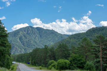 Mountain peaks and asphalt highway. Russia, mountain Altai