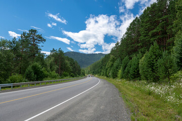 Mountain peaks and asphalt highway. Russia, mountain Altai