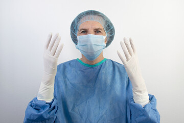 Fototapeta na wymiar old senior female woman surgeon uniform doctor medical gloves surgical hair net