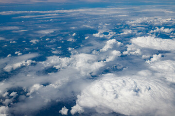Aerial view to beautiful clouds from plane. Flight from Helsinki to Amsterdam.