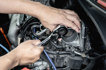 Hand a man hold wrench in car service engine throttle valve cleaning and maintenance : car service...