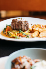 Steak and potatoes in a restaurant mood