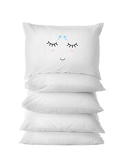 Stack of soft pillows, one with cute face on white background
