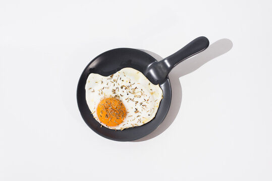 Tasty fried egg on skillet in white table