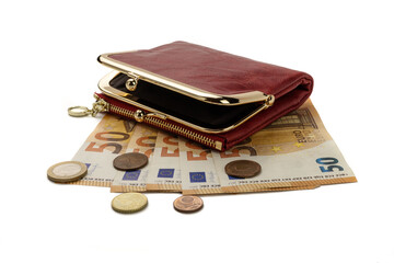 A red purse lying on fifty euro notes and coins, isolated