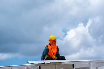 Roofer working at metal profile roof installation,Roofing tools,Electric drill used on new roofs.