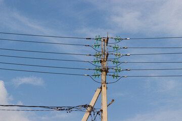 Concrete electrical power line utility pole with green glass insulators and six parallel connected...