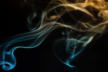 Abstract colored smoke moves on dark background. Wallpaper. Personal vaporizers fragrant steam. Concept of alternative non-nicotine smoking. E-cigarette. Texture. Design elements.