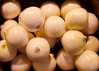 Onions close up on a market stall background 