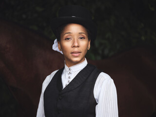 Confident black lady near horse in countryside