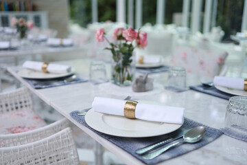 The wedding decor. Tables set for an event party or wedding reception. luxury elegant table setting dinner in a restaurant. glasses and dishes. hall for banquets and weddings.