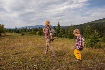 Happy family resting in the mountains in autumn