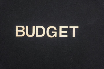 BUDGET word written on dark paper background. BUDGET text for your concepts