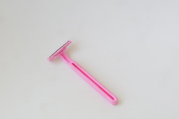 used pink beard razor on white isolated background