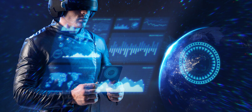 Man with futuristic tablet in hand. Guy using VR glasses. Planet Earth from space at night. Elements of this image furnished by NASA. Futuristic holographic loading interface.
