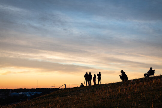 Silhouettes of a group of people watching the sunrise