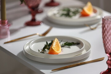 White plate decorated on white table and pink glass. Wedding decoration.

