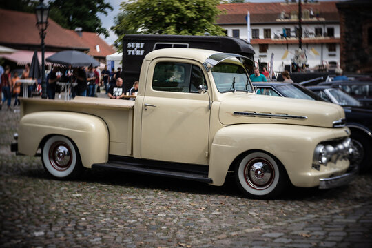 DIEDERSDORF, GERMANY - AUGUST 21, 2021: The full-size pickup truck Ford F-1, 1951. Focus on center. Swirly bokeh. The exhibition of "US Car Classics".