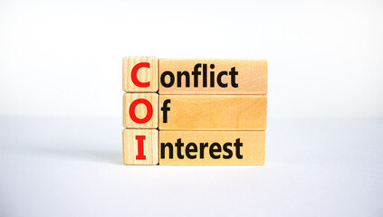 COI, Conflict of interest symbol. Wooden blocks with concept words 'COI, conflict of interest'....