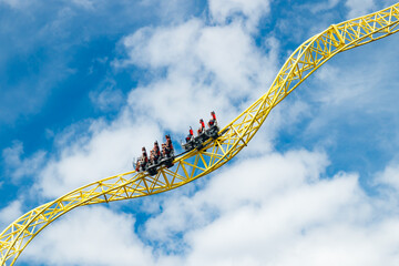 Ride roller coaster in motion in amusement park.