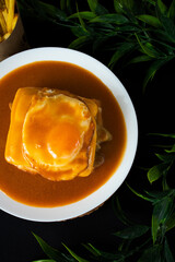 Typical portuguese dish: francesinha with french fries.
