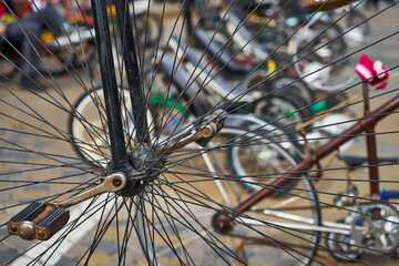 An image of a large old-fashioned bicycle wheel and pedals.
