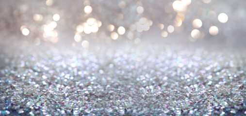 Shiny glitter and blurred lights on background, banner design. Bokeh effect