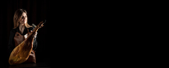 young woman holding a Full leg of Spanish jamon iberico, Jamon Serrano, Bellota, Italian Prosciutto Crudo or Parma ham