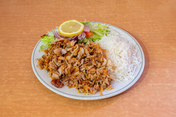 Menu mixed kebab dish garnished with basmati rice and salad with red onion and lemon tomato for seasoning