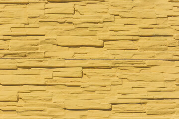 Yellow paint on surface stone tile bright wall modern texture background