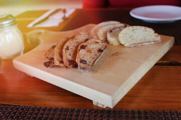slices of classic loaf and with fruits on rustic table. bread