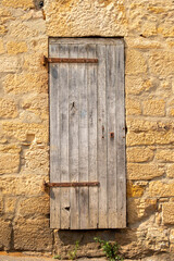 Old wooden door in Europe.  Limestone house.