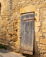 Old wooden door in Europe.  Limestone house.