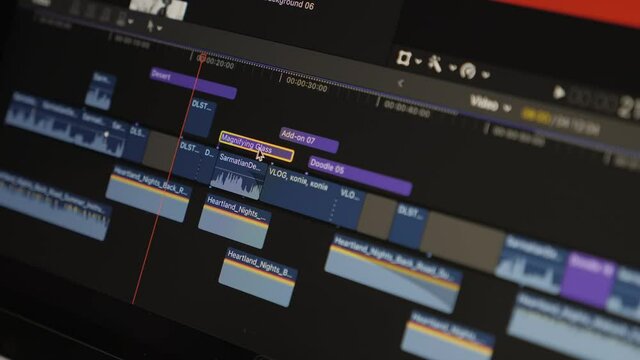 Video editing on computer. Footage editing timeline and computer monitor. Video processing