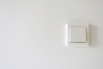 White light switch on a white wall.