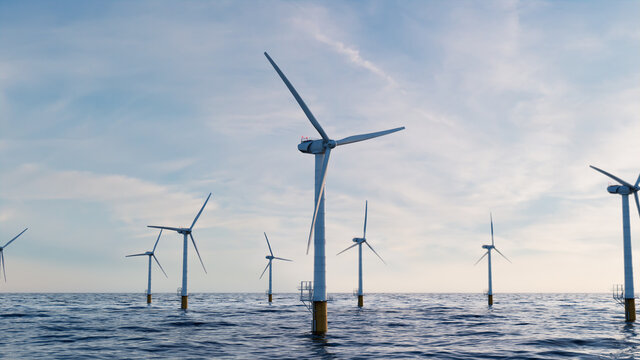 Wind Turbines. Offshore Wind Farm at Dusk. Sustainable Power Concept.