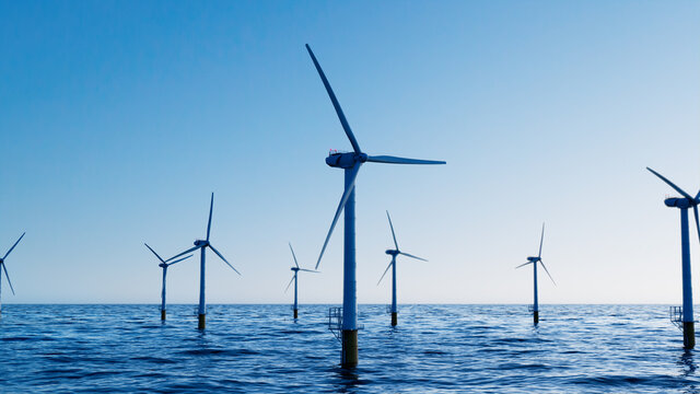 Wind Power. Offshore Wind Turbines on a Clear Evening. Environmental Power Concept.