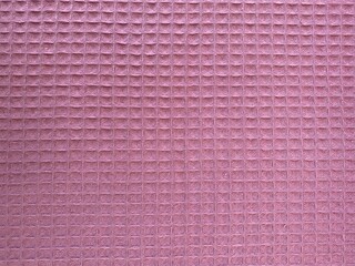 Waffle textured cotton fabric close up in rose pink