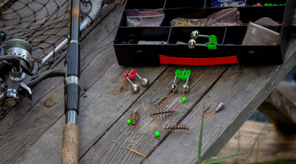Fishing tackle on the river bank, bait rod, spinning rod, fish. Selective focus