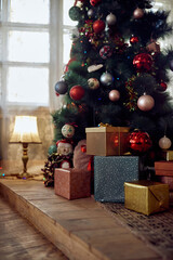 Wrapped gifts under Christmas tree at home.