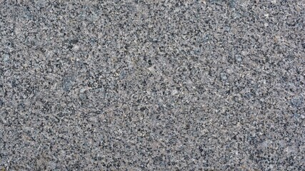 Textured decorative background of dark gray granite with space for text