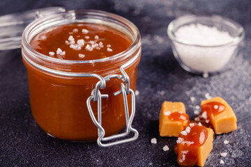 Glass jar with tasty delicious salted caramel