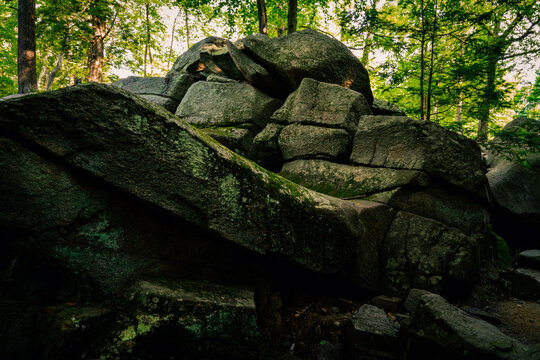 Majestic glacial stone hill at Purgatory Chasm Park in Massachusetts. Abstract geological shapes and patterns of curving flow and mystical power.