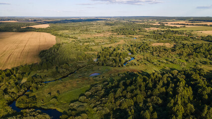 Village among green forest, peace and quiet. The harvest was removed. Countryside background.