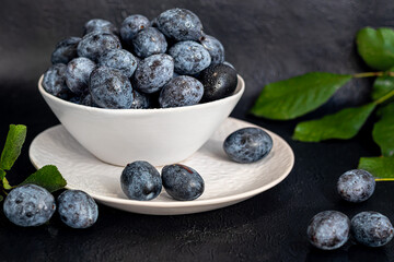 Plums on a dark background. Harvesting the autumn harvest. Making jam and sauce. Still life.