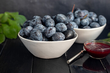 Plums on a dark background. Harvesting the autumn harvest. Making jam and sauce. Still life.