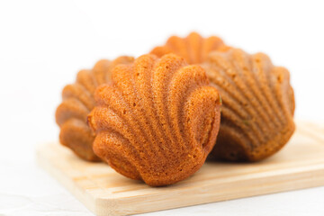 Madeleine cakes with a distinctive shell-like shape on white background for bakery, food and eating concept