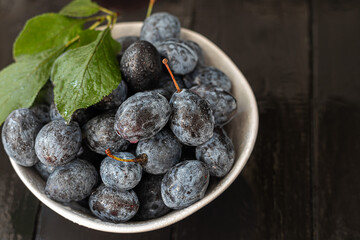Plums on a dark background. Harvesting the autumn harvest. Making jam and sauce. Still life.