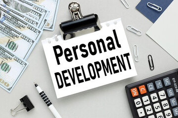 Personal Development. text on white paper on gray background near money.